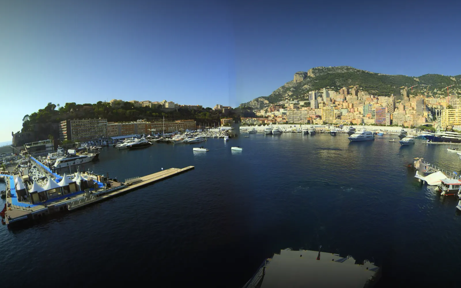 360° panorama of Port Hercule, Monaco, from the masthead camera — the marina, superyachts and the hillside town.